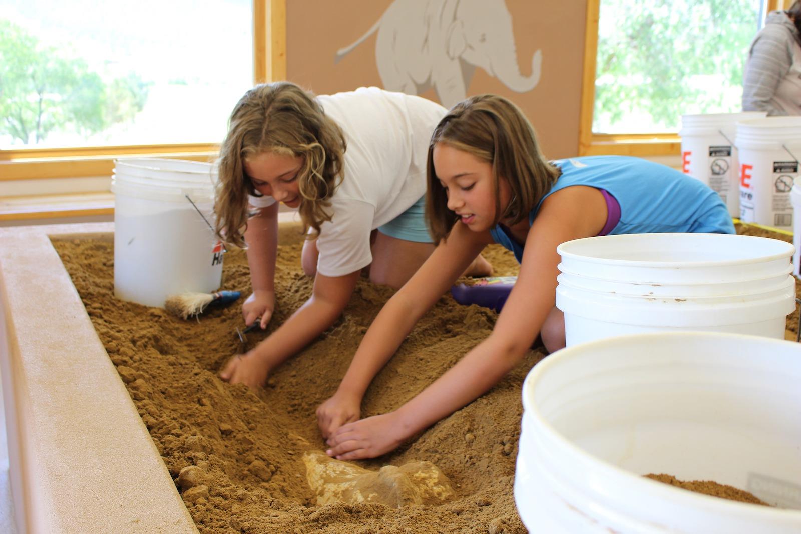 two kids dig up fossils in Hot Springs, South Dakota