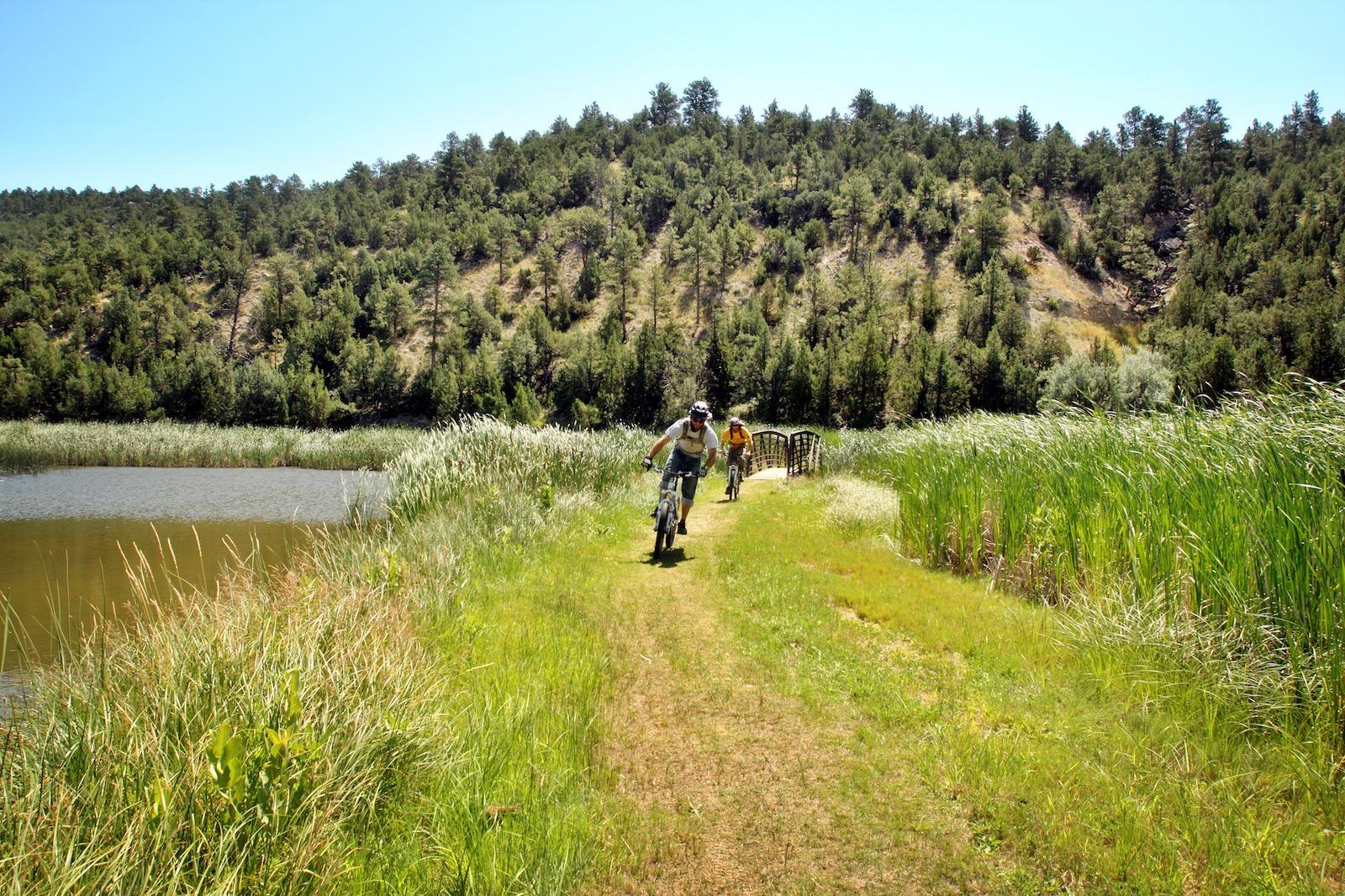 Two mountain bikers on family vacation on an easy trail along Glendo State Park in Platte County, Wyoming