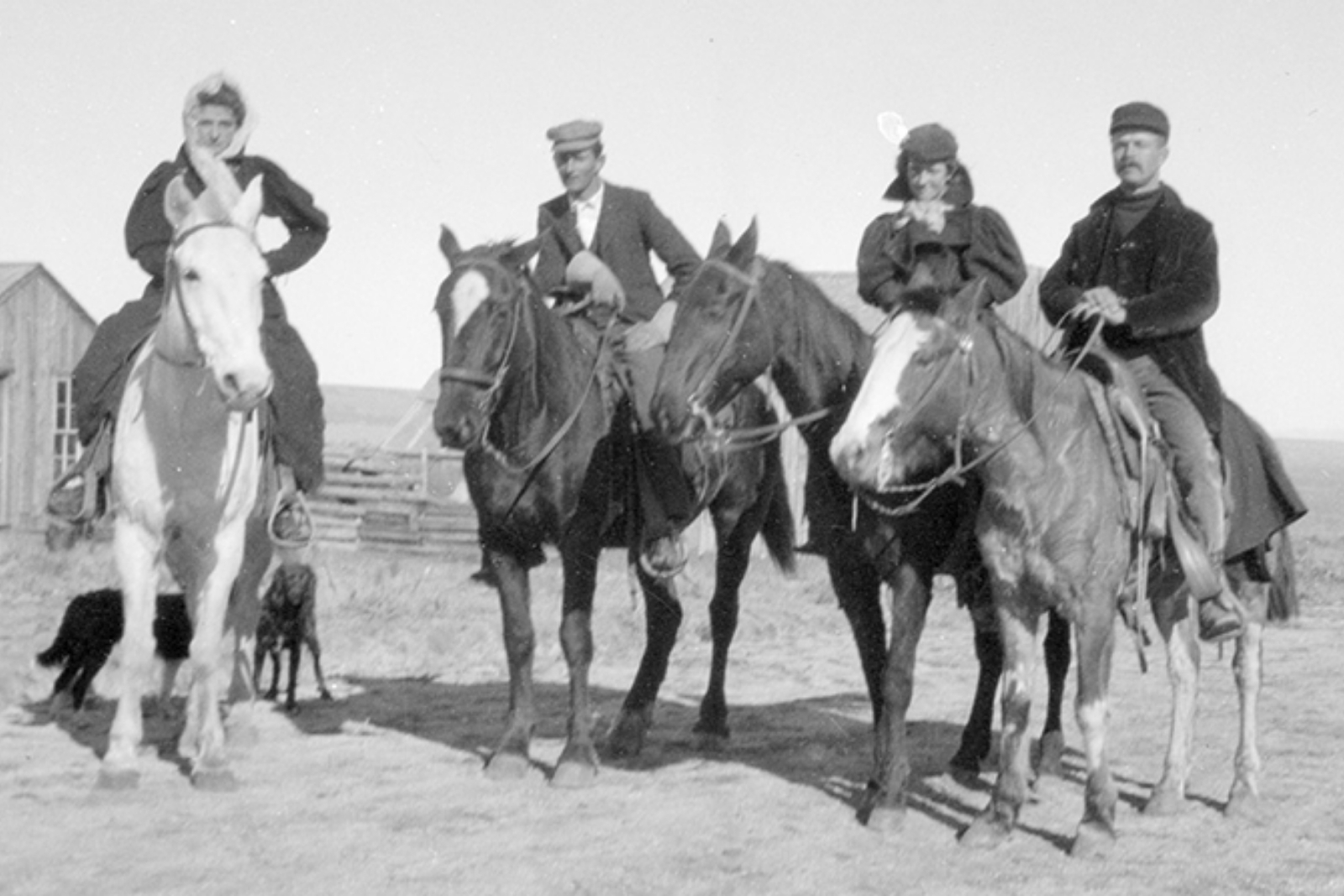 A group of people on horses in a black and white photo