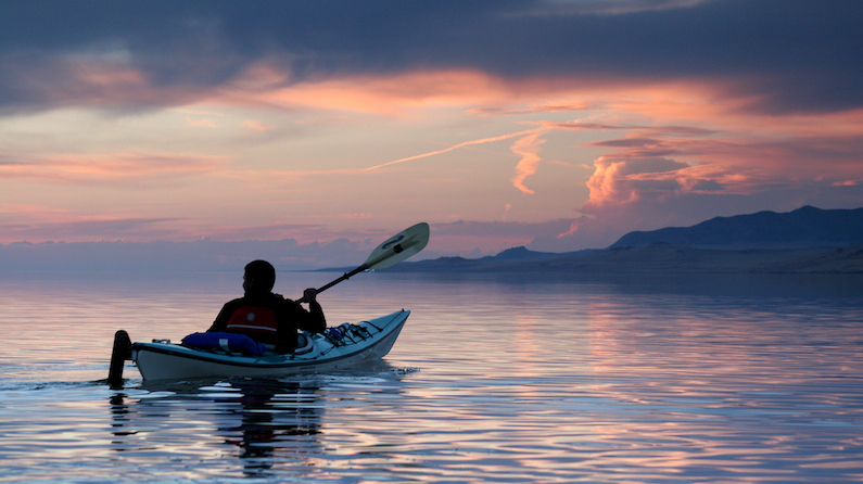Kayaker on the Great Salt Lake at sunset
