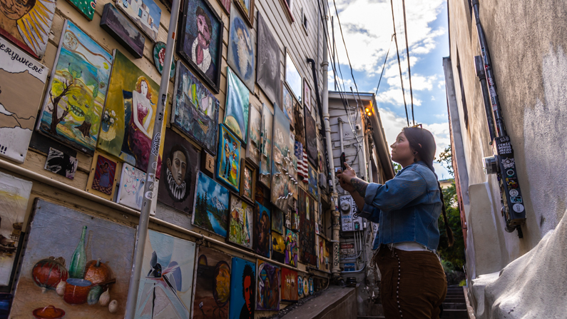 woman taking photo of artwork in Bisbee
