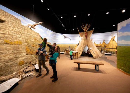 Family looking at exhibits at First Peoples' Buffalo Jump State Park