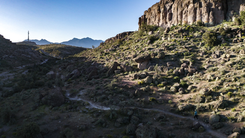Woman walking on a trail in desert landscape