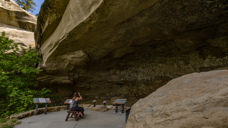 Woman looking at Pictograph Caves 