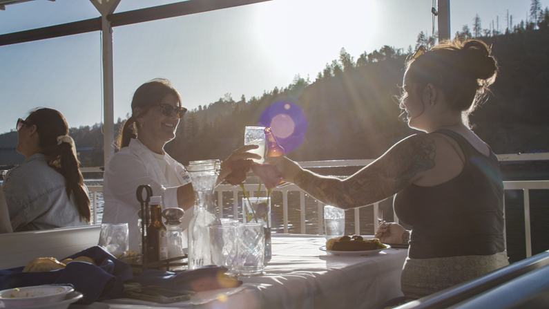 Women cheers on dinner cruise on Shasta Lake