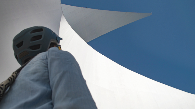 Woman looking up at Sun Dial Bridge in Redding, CA