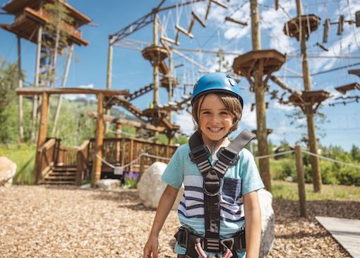 Child in front of aerial ropes course in Jackson Hole Mountain Resort