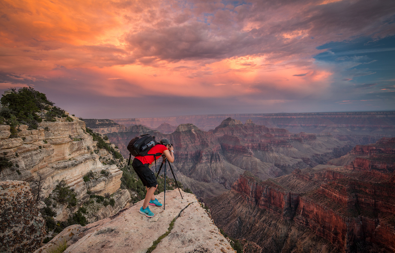 This is my friend Sarah AlSayegh photographing a great sunset on the North Rim of the Grand Canyon. There's a funny story I have to share on this one. When we first arrived at this spot, there was a girl sitting off to the side jabbering away on her cell phone. I was surprised she even got cell phone reception there. We walked out to the point and started setting up. Then inexplicably, the girl came and sat down right in front of our tripods, still jabbering away on her phone. We thought that was odd and had to adjust our compositions to keep her out of it. When she was done talking, she turned to us and said what we had done was the rudest thing she'd ever seen. She said her sister was a professional photographer (I don't know why that had anything to do with the conversation). And then she hoped that we wouldn't get a single good photograph on our entire trip. Sarah was great, and just responded with a happy "thank you!" The girl left in a huff and we were rewarded with this great sunset.