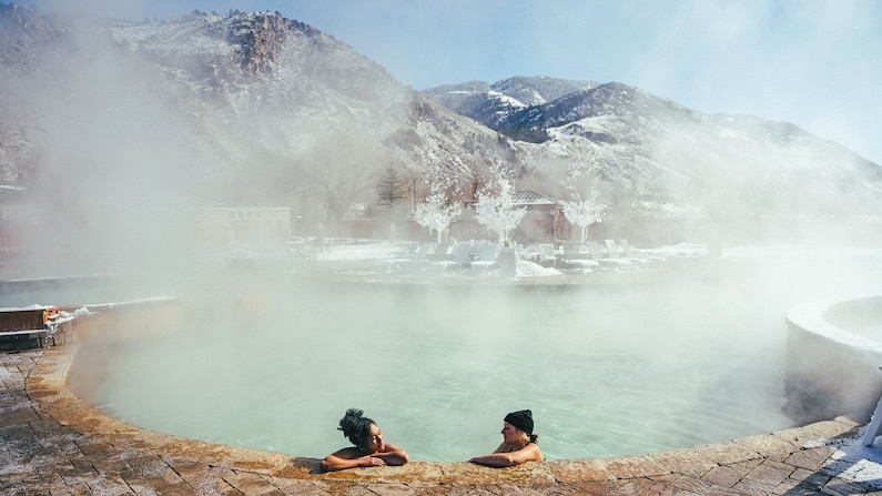 Two people soaking in Yellowstone Hot Springs, Gardiner, Montana