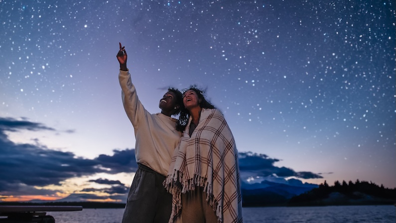 Two people enjoying stargazing in Maine