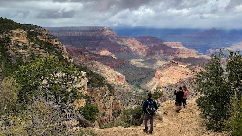 Hikers on the South Rim of the Grand Canyon near Tusayan, Arizona.