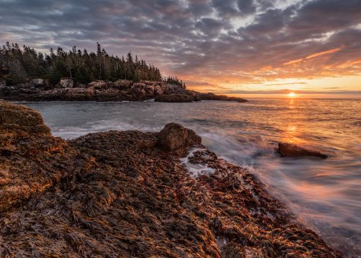 Sunset view of cliffs over the sea at Acadia National Park
