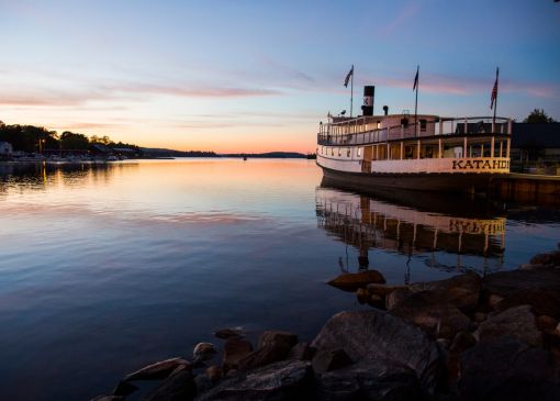 Ferry floating on the water at sunset