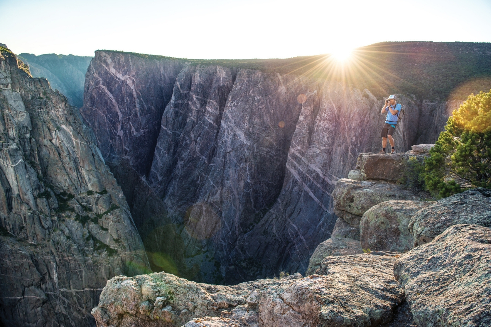 A person standing on the edge of the Black Canyon of the Gunnison.
