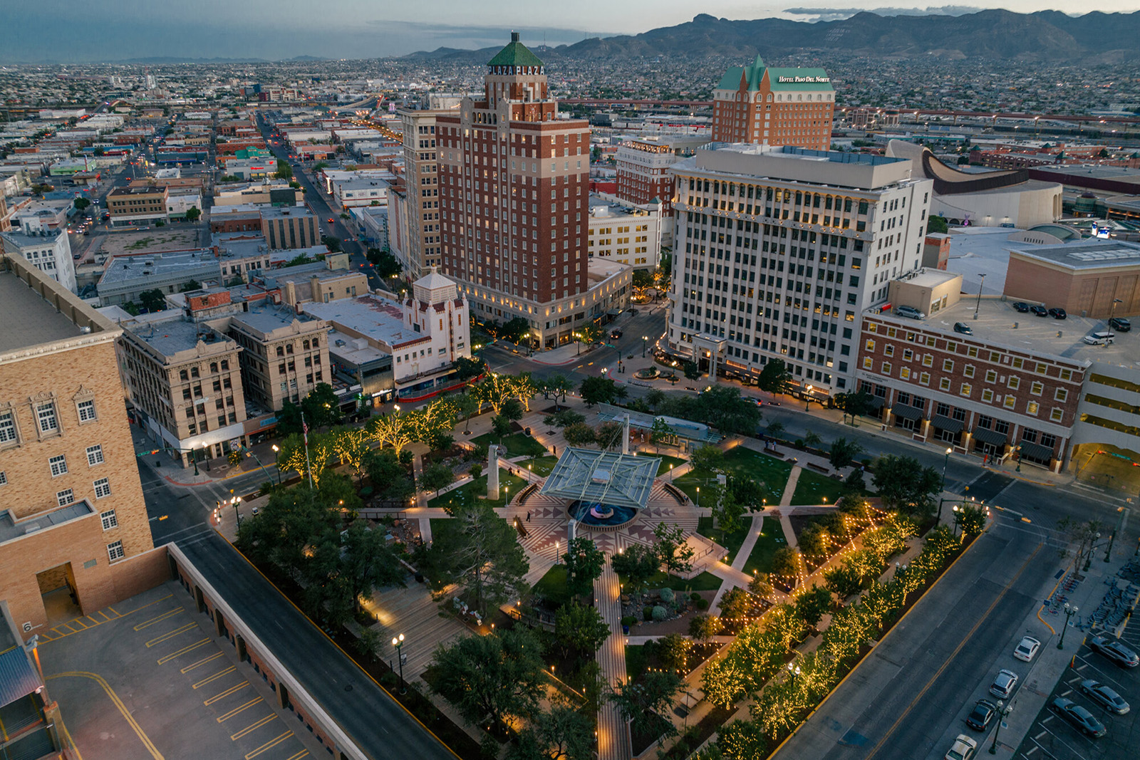 Aerial evening view of San Jacinto Plaza and downtown El Paso, Texas, with the Franklin Mountains beyond.
